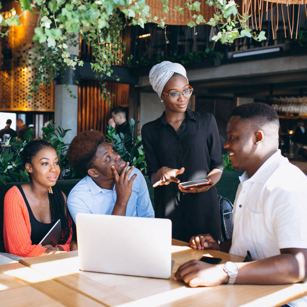 Business people using computer in cafe